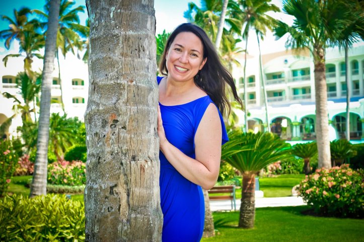 New Profile Picture - woman (Colette) in a blue dress by a palm tree in the Caribbean. 